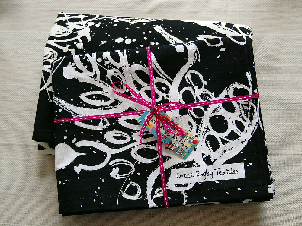 Black Tea Towel. Birds and Leaves Design.