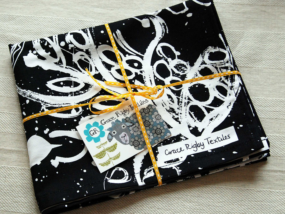 Black Tea Towel. Birds and Leaves Design.